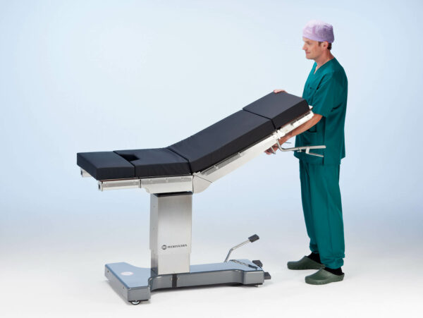 The nurse adjusts the back section of Practico Manual operating table.