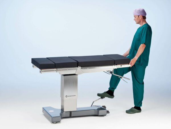 The nurse adjusts the hight of Practico Manual operating table.