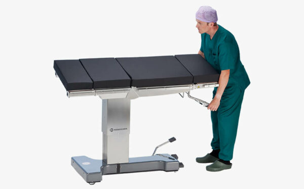 The nurse adjusts tilt of Practico Manual operating table.
